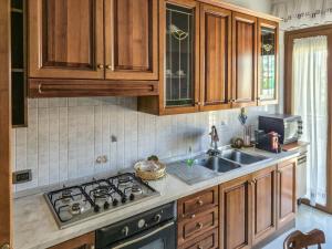 a kitchen with wooden cabinets and a stove top oven at DeLiA in Avellino +23 photos