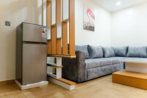 a living room with a couch and a refrigerator at Hola Rio in Dakhla