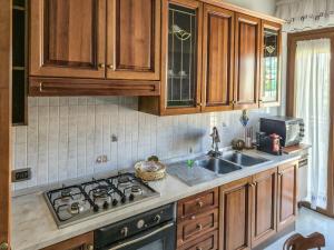a kitchen with wooden cabinets and a stove top oven at DeLiA in Avellino