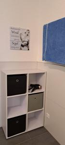 a white cabinet with drawers and a blue towel at Ferienwohnung Am Stadttor in Tann