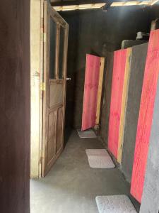 a hallway with two open doors in a room at Camping & Glamping For All in Itaúnas