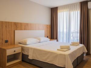 a bedroom with a bed with two towels on it at Mimoza Apart in Trabzon