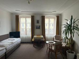 a bedroom with a bed and a table and chairs at ubytování U Šeniglů in Telč