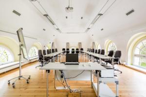 a large room with a long table and chairs at Hotel Schloss Storkau in Storkau
