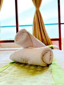 a towel sitting on top of a bed at La Couronne Seaview Resort in Pondicherry