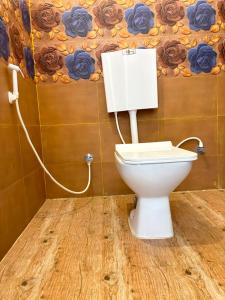 a bathroom with a white toilet in a room at La Couronne Seaview Resort in Pondicherry +28 photos