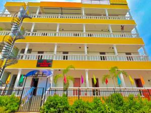 a building with balconies and flags on it at La Couronne Seaview Resort in Pondicherry