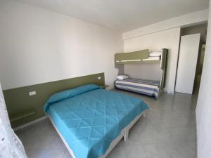 a bedroom with a bed and bunk beds in it at Ginestra in Galtellì