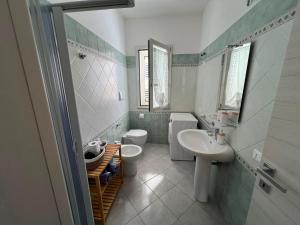 a bathroom with a sink and a toilet and a sink at Ginestra in Galtellì