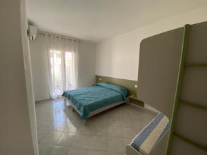 a small bedroom with a bed and a window at Ginestra in Galtellì