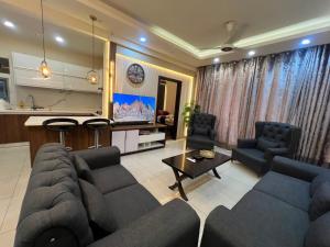 a living room with a couch and a table at ELYSIUM TOWER Luxury Hotel Apartments Facing Centaurus Mall Islamabad in Islamabad