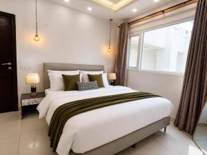 a bedroom with a large bed and a window at ELYSIUM TOWER Luxury Hotel Apartments Facing Centaurus Mall Islamabad in Islamabad +107 photos