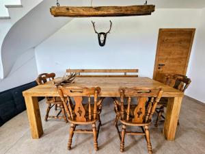 a dining room with a wooden table and chairs at Pirman Vineyard Cottage in Bučka