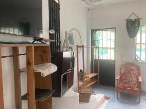 a living room with a refrigerator and a table at Casa Ozomalli in San Pedro Pochutla