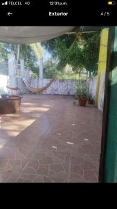 a view of a patio with a hammock in a yard at Casa Ozomalli in San Pedro Pochutla