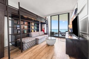 a living room with a couch and a television at Kimpton Seafire Resort + Spa by IHG in West Bay