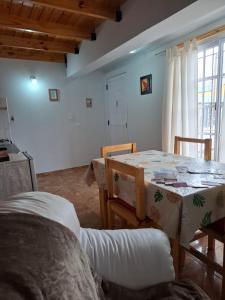 a dining room with a table and chairs and a window at Brisas Andinas in Malargüe