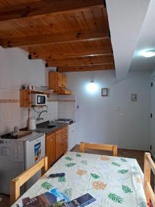a kitchen with a table and a stove top oven at Brisas Andinas in Malargüe +6 photos