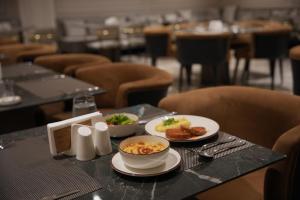 a table with two plates of food on it at Park Dedeman Sisli in Istanbul