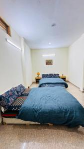 a bedroom with two beds in a room at CLOUD HEIGHTS COTTAGE NATHIA GALi in Nathia Gali