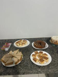 a bunch of different types of cakes on plates on a counter at Hotel Goiamat in Querencia