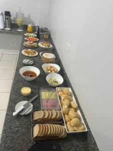a long table filled with different types of food at Hotel Goiamat in Querencia