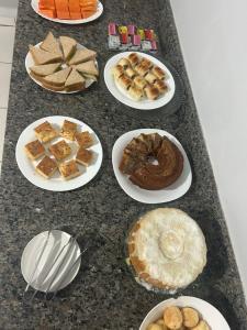 a table topped with plates of different types of desserts at Hotel Goiamat in Querencia +5 photos