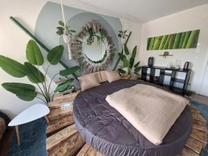 a bedroom with a large bed in a room with plants at Jungle Dream in Hitzkirch