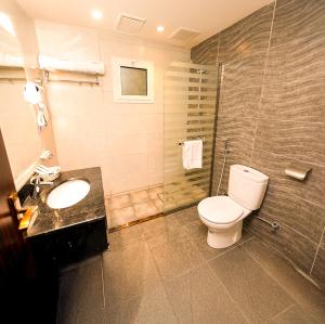 a bathroom with a toilet and a sink and a shower at Moments in Jeddah +31 photos