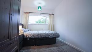 a small bedroom with a bed and a window at Whitebeam in Solihull +26 photos