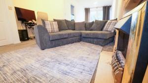 a living room with a couch and a rug at Whitebeam in Solihull
