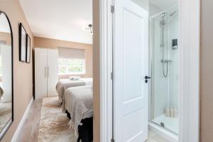 a bedroom with a bed and a glass shower at Meadow Park Villas in Manchester +108 photos