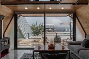 a living room with a couch and a table at Maison Jwar - Luxury A-Shape Cabins - A Unique Summer Getaway in Ḩārat at Taḩtā