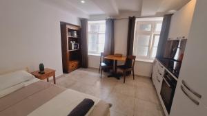a bedroom with a bed and a desk and a table at Basel city in Basel