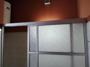 a sliding glass door in a bathroom at La negrita in Villa Elisa
