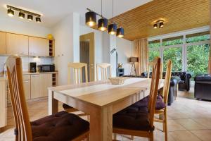 a kitchen and dining room with a wooden table and chairs at Haus 17 in Röbel