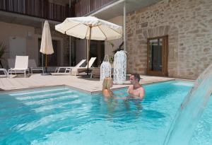 a man and a woman in a swimming pool at Forum Boutique Hotel & Spa - Adults Only in Alcudia