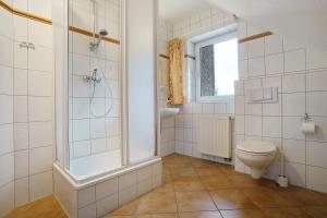a bathroom with a toilet and a shower at Haus 17 in Röbel +21 photos