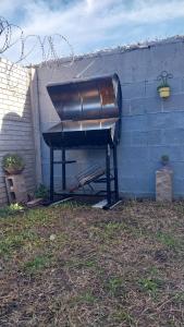 a black piano sitting next to a wall at La casita de Susi in San Pedro