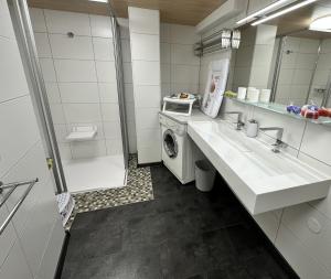 a bathroom with a sink and a washing machine at apart-gerlos in Gerlos +43 photos