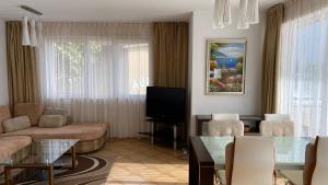 a living room with a couch and a tv at Bellevue Beachfront Paradise in Ravda