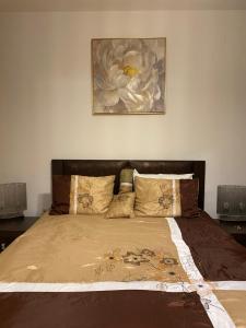 a bedroom with a bed with a painting on the wall at Bellevue Beachfront Paradise in Ravda +42 photos