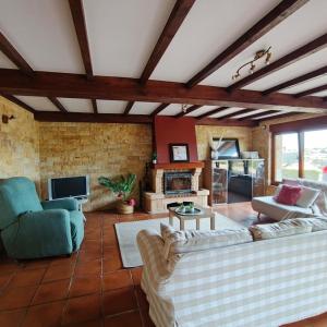 a living room with two couches and a fireplace at Casa Dulce in Villaviciosa