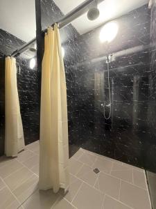 a bathroom with a shower with a shower curtain at ADAM Hostel Krāslava in Krāslava +13 photos
