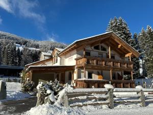a house in the snow with a fence in front at apart-gerlos in Gerlos