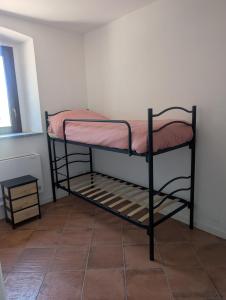 a small bunk bed in a room with a tile floor at Monterosa Apartment in Morghengo +3 photos