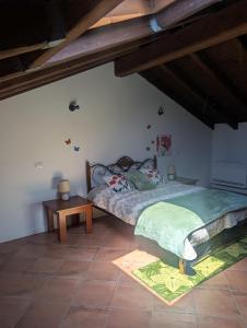 a bedroom with a large bed and a table at Monterosa Apartment in Morghengo