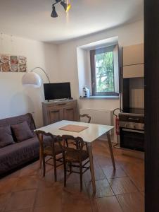 a living room with a table and a couch at Monterosa Apartment in Morghengo