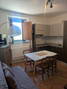 a kitchen with a table and chairs and a couch at Monterosa Apartment in Morghengo