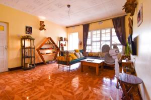 a living room with a couch and a table at Utamaduni House B&B in Arusha